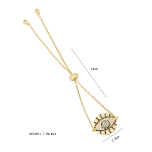Detail shot of a golden evil eye zircon bracelet with adjustable chain and dimensions