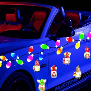 Close-up of colorful Christmas bulb magnets and festive gnomes on a car's blue exterior