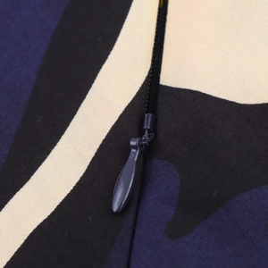 Macro detail of high-quality invisible metal zipper on colorful floral print woven skirt