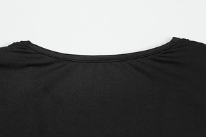 Detailed macro view of the round neckline on a solid black slim fit knitted dress