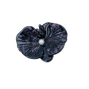 Elegant acetate orchid hair clip with marble texture and pearl accent on white background