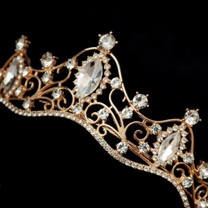 Macro shot of rose gold bridal tiara with sparkling crystals against black background