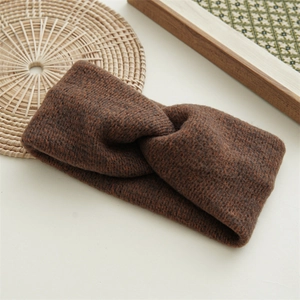 Close-up of coffee brown knit twisted headband with detailed wool texture on a tray
