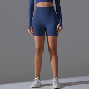 Detail showing high-waisted seamless ribbed waistband on dark blue fitness shorts