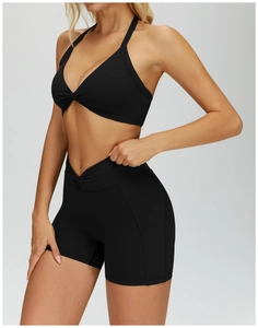 Detail of black halter yoga set featuring twist knot design and high elasticity fabric