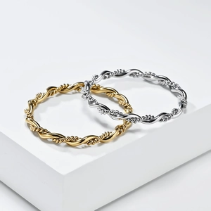 French style twisted rope braided rings in gold and silver finish on white stand