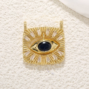 Macro shot of evil eye pendant with blue center stone and white zircon starburst
