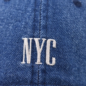 Blue washed denim baseball cap with white NYC letter embroidery and vintage texture