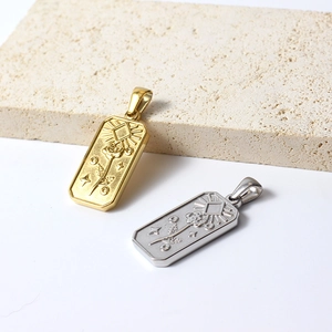 Macro detail of gold and silver rectangle sunflower charms on a textured stone