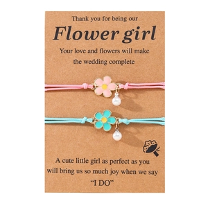 Detail of pink and blue enamel flower bracelets with pearls on Flower Girl gift card