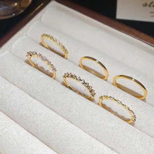 Set of 6 gold geometric rings with sparkling zircon stones in a velvet jewelry box