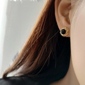 Vintage 925 silver stud earrings with black onyx on gold base worn by model