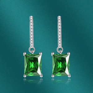 Detail of square emerald green cubic zirconia earrings with silver micro-pave ear hooks