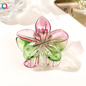 Detail view of large translucent pink and green gradient flower hair claw clip