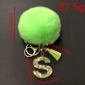 Green faux fur pompom keychain with resin letter S and golden tassel accessory