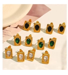 Collection of teardrop crystal square earrings in gold, emerald green, and black stones