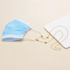 Detail of gold-plated stainless steel mask chain with hollow butterfly charms and lobster clasps