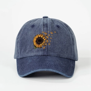 Detail of sunflower and butterflies print on vintage washed navy blue baseball cap