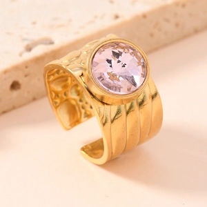 Luxurious gold titanium ring with a faceted pink gemstone in a vintage embossed style