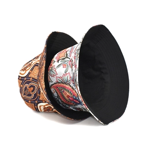 Detailed view of dual-sided bucket hats featuring paisley patterns and floral designs