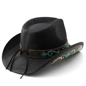 Detail of black straw cowboy hat featuring ethnic embroidery and leather hatband