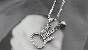 Close-up of skull and guitar pendant necklace with integrated bottle opener feature