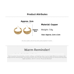Detail view of gold-plated multi-layer C-shaped earrings with 2cm diameter and 7.8g weight