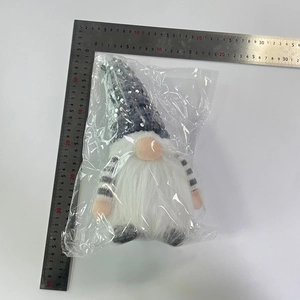 Glittering gray gnome doll measured with a ruler, standing approximately 30cm tall