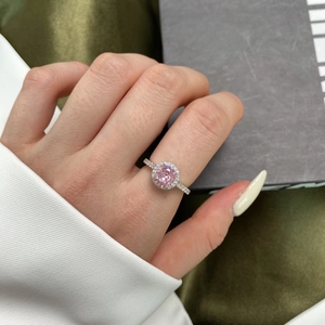 Close-up of s925 silver ring featuring a vibrant pink zircon stone on a woman's finger