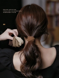 Detail of high-elasticity coffee-toned seamless hair ties in a ponytail use case
