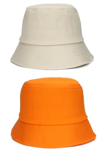 Detail of cotton bucket hats with reinforced stitching in beige and bright orange colors