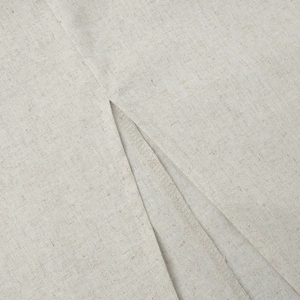 Macro view of natural linen texture and professional stitching on skirt side slit