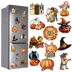 Macro shot of Halloween gnome and pumpkin magnetic stickers on a metal surface