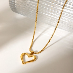 Elegant gold hollow heart pendant necklace with box chain on a minimalist white background