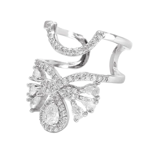 Macro detail of silver ring with butterfly motif and zircon pavé on a white background