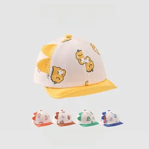 Detail of baby soft brim hats featuring cartoon dinosaur patterns in five vibrant colors
