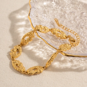Detail of 18K gold-plated stainless steel bracelet with vintage lava texture on glass