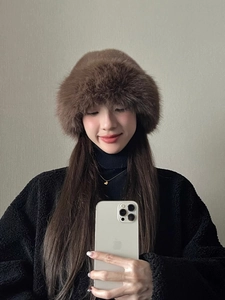 Close-up of thick dark brown faux fur bucket hat with soft plush texture for winter