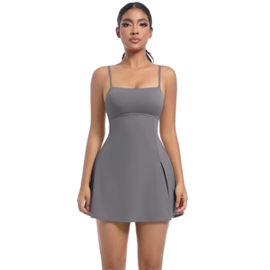 Detail view of grey tennis dress featuring thin straps and side slit for mobility