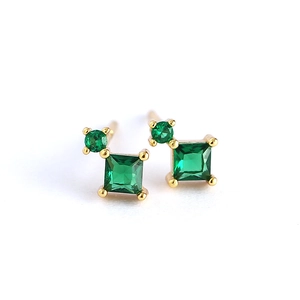 Elegant gold earrings with square green stones and small round gems on a white background