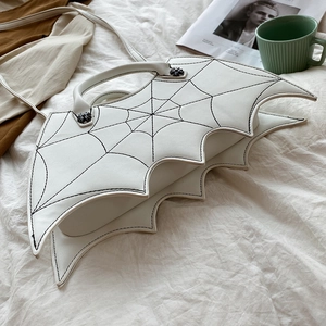 Detailed view of a white PU leather bat wing handbag with black decorative stitching