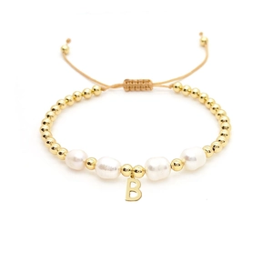 Detailed close-up of Baroque pearl bracelet with 18K gold beads and letter B charm