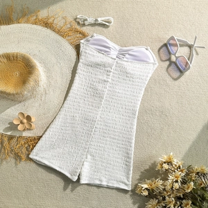 Detail of white smocked one-piece swimsuit with sweetheart neckline and ribbed texture