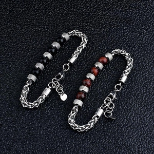 Detail of tiger eye beaded bracelets with stainless steel lobster clasp on black leather