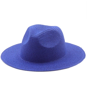 Detail of royal blue woven straw fedora hat with fine texture and classic wide brim
