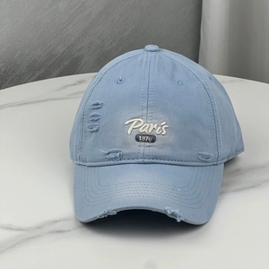 Sky blue distressed baseball cap with Paris 1976 embroidery and vintage ripped details