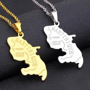 Macro view of gold and silver Martinique map pendants with city names on black leather