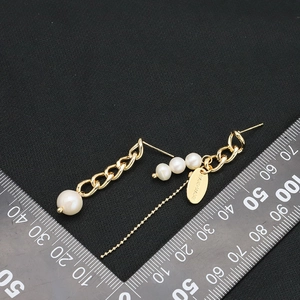Asymmetric gold plated natural baroque pearl drop earrings with handmade tag detail