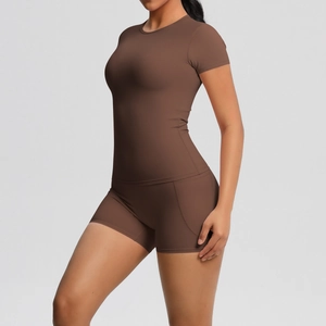 Detail view of high-elasticity dark brown yoga set featuring side structural stitching