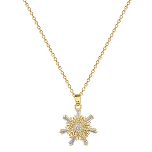 Elegant gold snowflake pendant necklace with sparkling crystals on white background